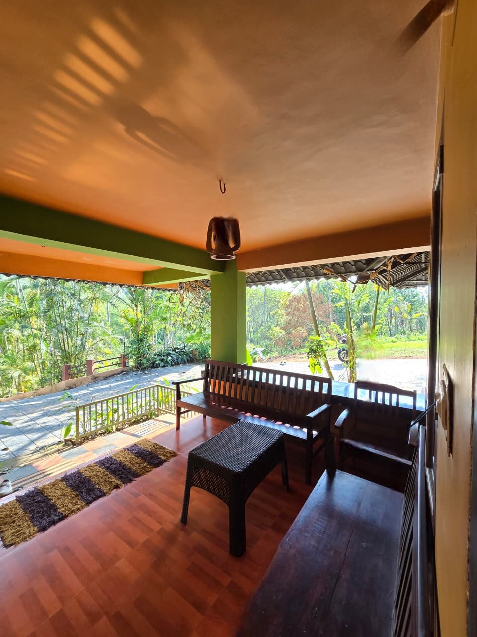 Shaded sit-out with wooden furniture